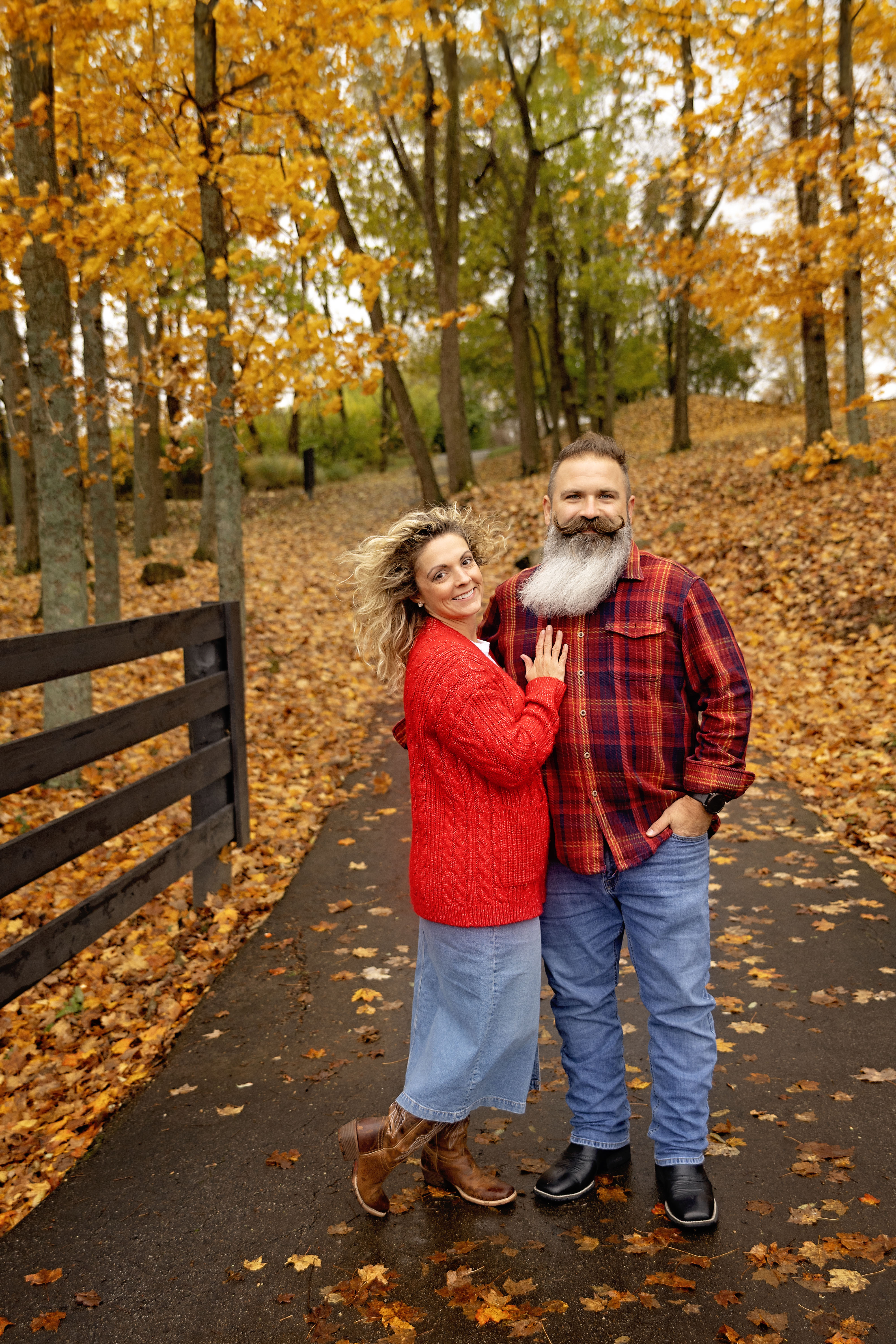 Jon and Tiffany Prabell — founders of Oak & Ash, surrounded by autumn leaves in Vevay, Indiana